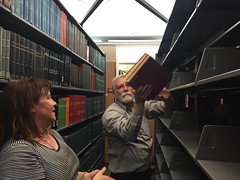 Steve Squires helps Monica Samsky move books in the basement